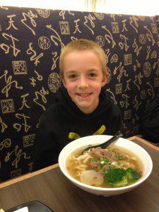 My adventurous son with his pork rib noodle bowl (March 2016).