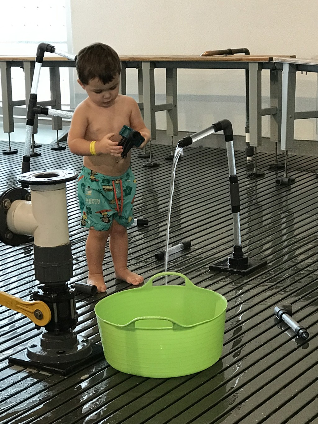 Child playing with water fountain at the Pittsburgh Children's Museum