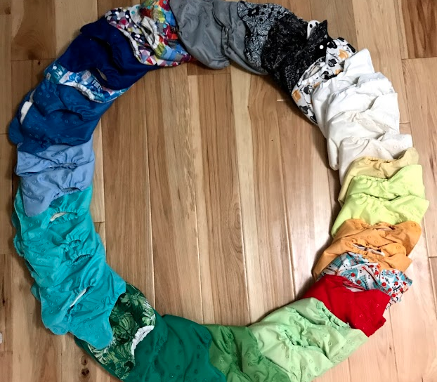 Cloth diapers laid in a circle sorted by color