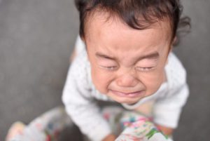 Toddler crying with eyes squeezed shut
